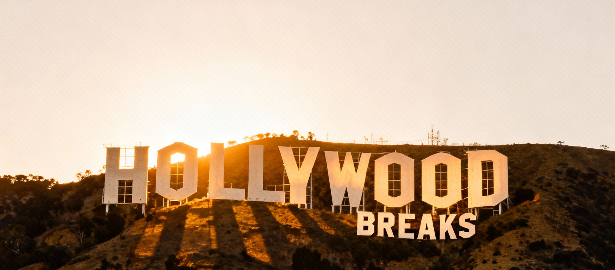 Hollywood Breaks sign on the hillside at dawn